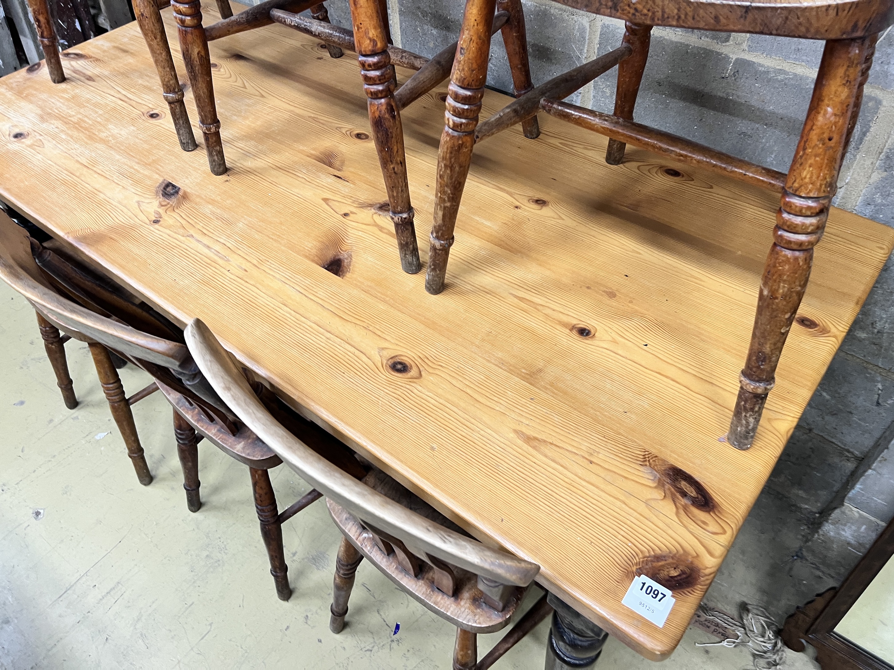 A Victorian style pine kitchen table with ebonised underframe, length 163cm, height 76cm and a set of six early 20th century lathe back kitchen chairs